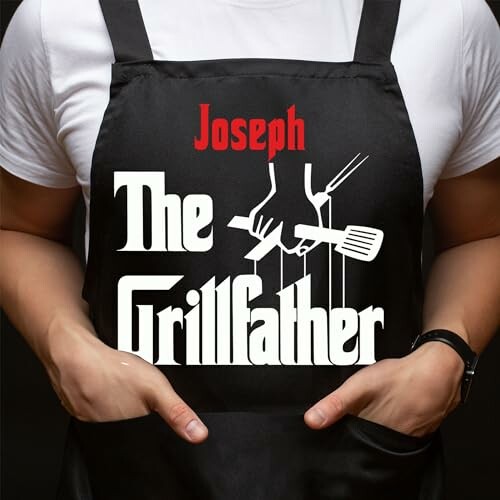 Person wearing apron with 'The Grillfather' design